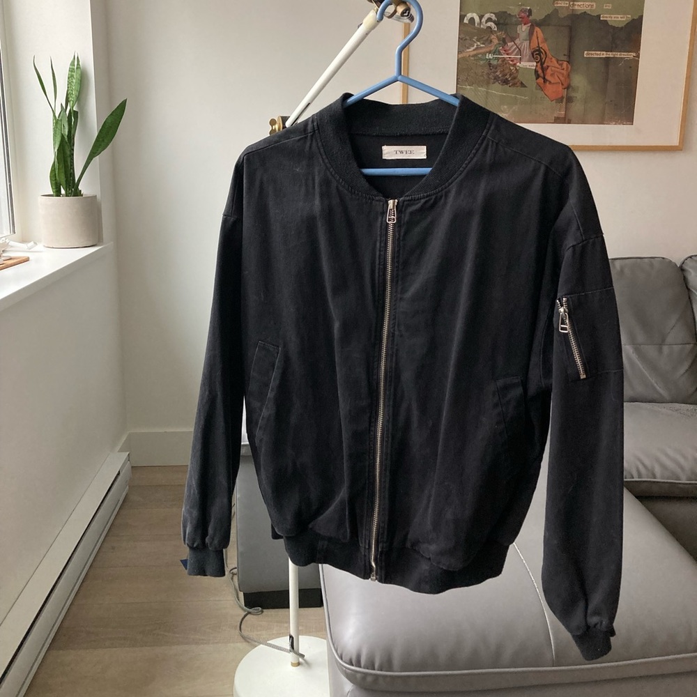 Black bomber jacket with zipper on the sleeve